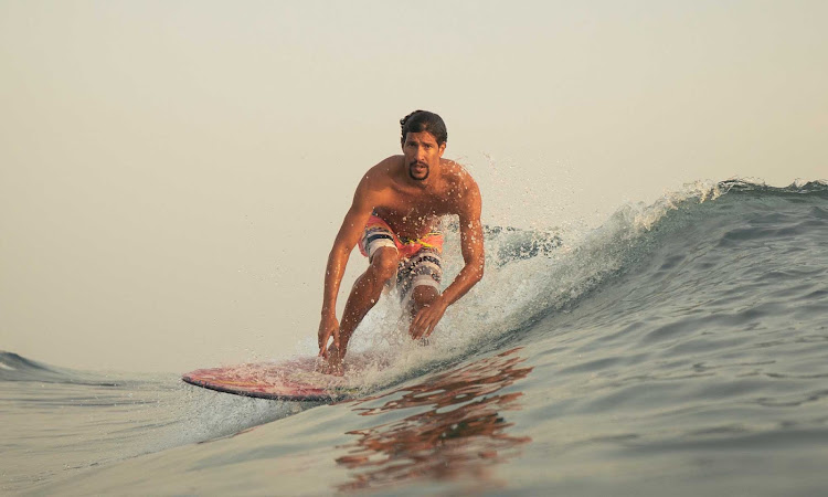 A surfer near Puerto Plata in the Dominican Republic.