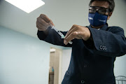 A healthcare worker prepares a dose of the Russian Sputnik V Covid-19 vaccine at a Comprehensive Diagnostic Center in the Mariperez neighborhood of Caracas, Venezuela, on Thursday, Feb. 25, 2021. 