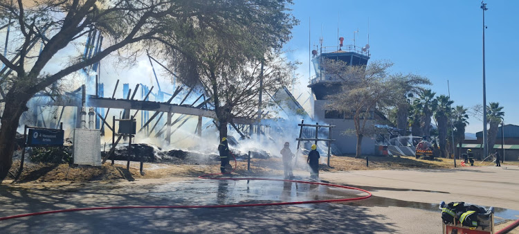 Firefighters try in vain to extinguish a fire that gutted the Pilanesberg International Airport on Tuesday.