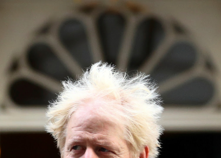 PM Boris Johnson walks outside Downing Street in London.