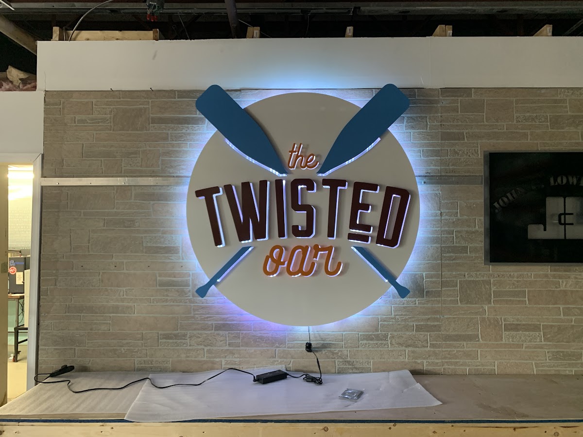 The Twisted Oar backlit metal business sign with warm LED illumination