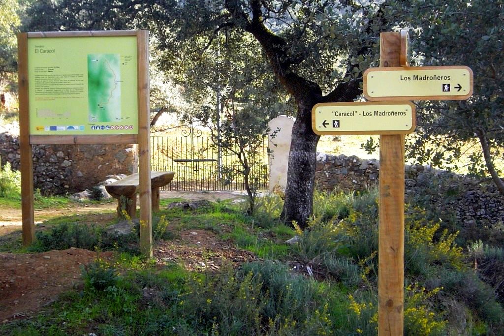 Wooden signs marking the walking routes to Los Madroñeros and El Caracol in the countryside outside Alájar.