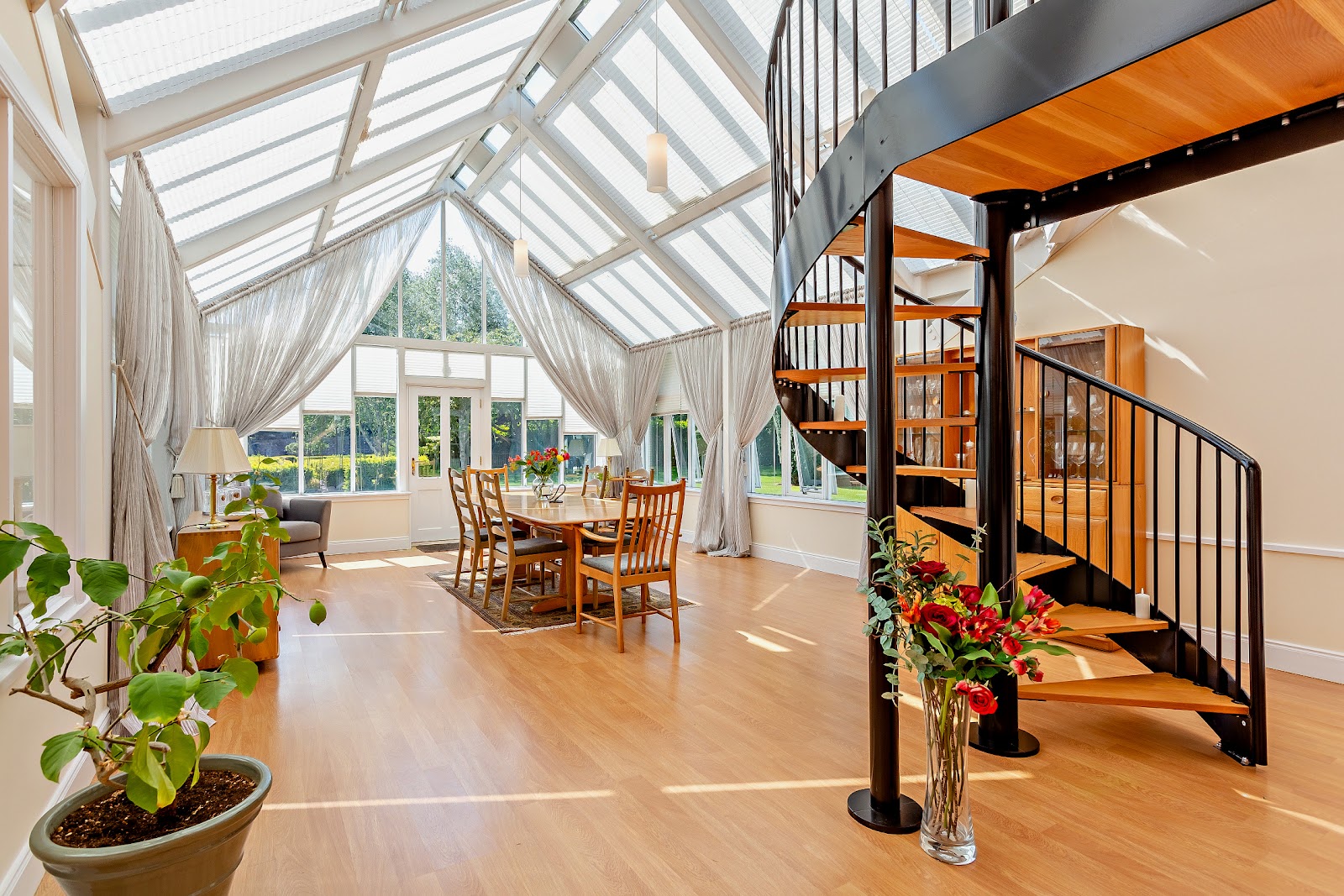 The spectacular 27ft glass-roofed dining room at 1 Arthurstone Gardens — flooded with natural light, overlooking the historic walled garden