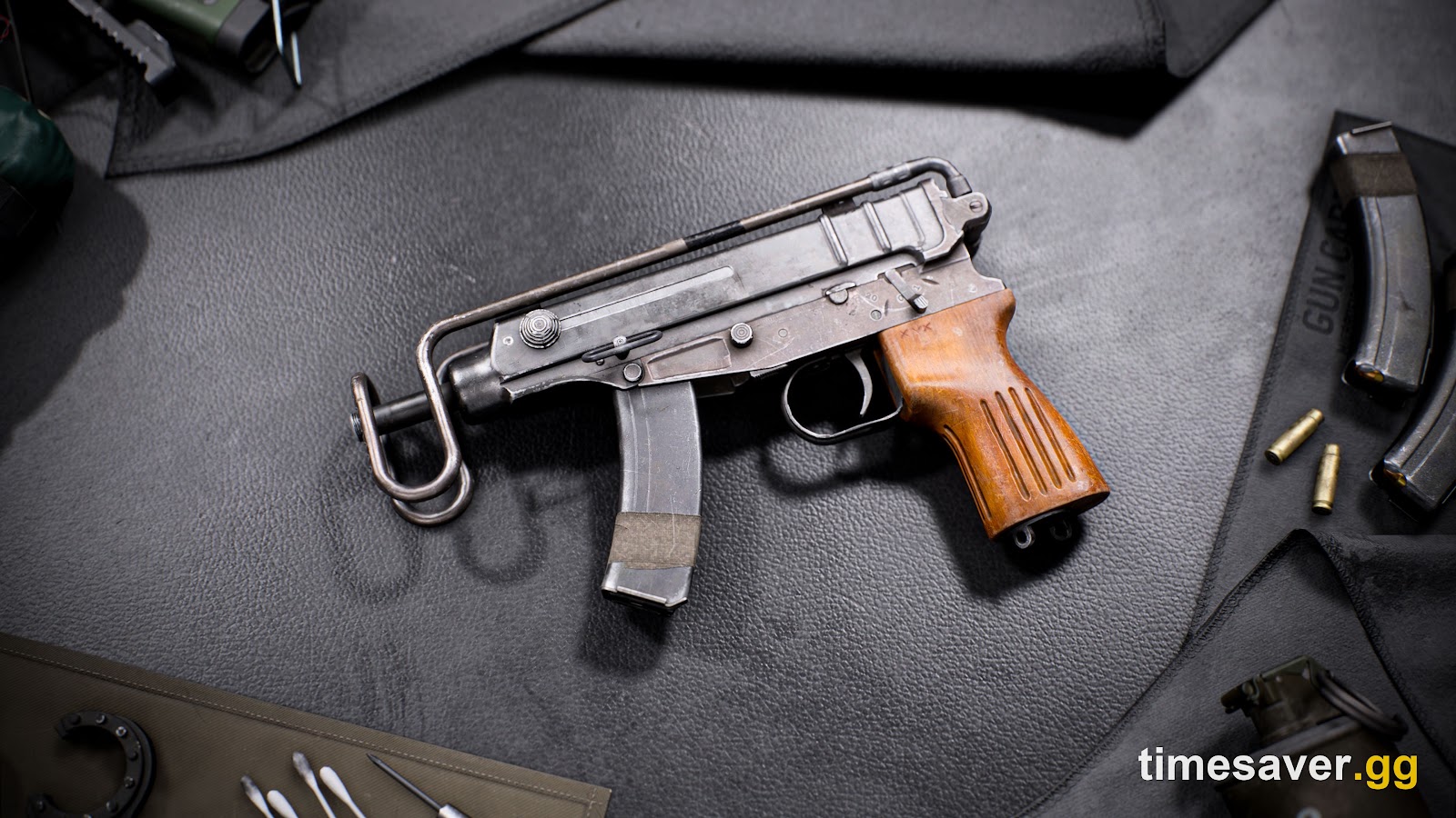 Close-up render of a compact Battlefield 6 machine pistol with a wooden grip and folding wire stock, beside spare magazines