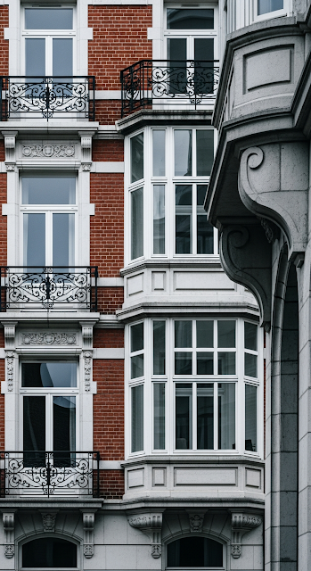 Close-up of Traditional Red Brick European Building with Ornate Balconies - Free mobile Wallpaper