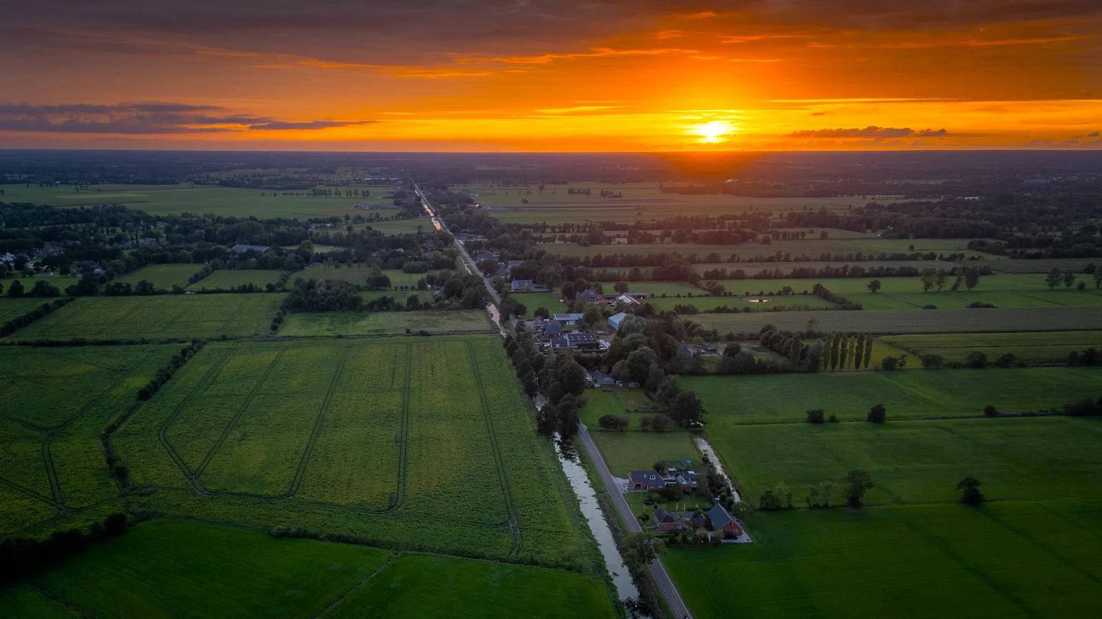 Golden Sunset Over Green Farmland - Aerial Photography 4K Wallpaper (3840x2160)