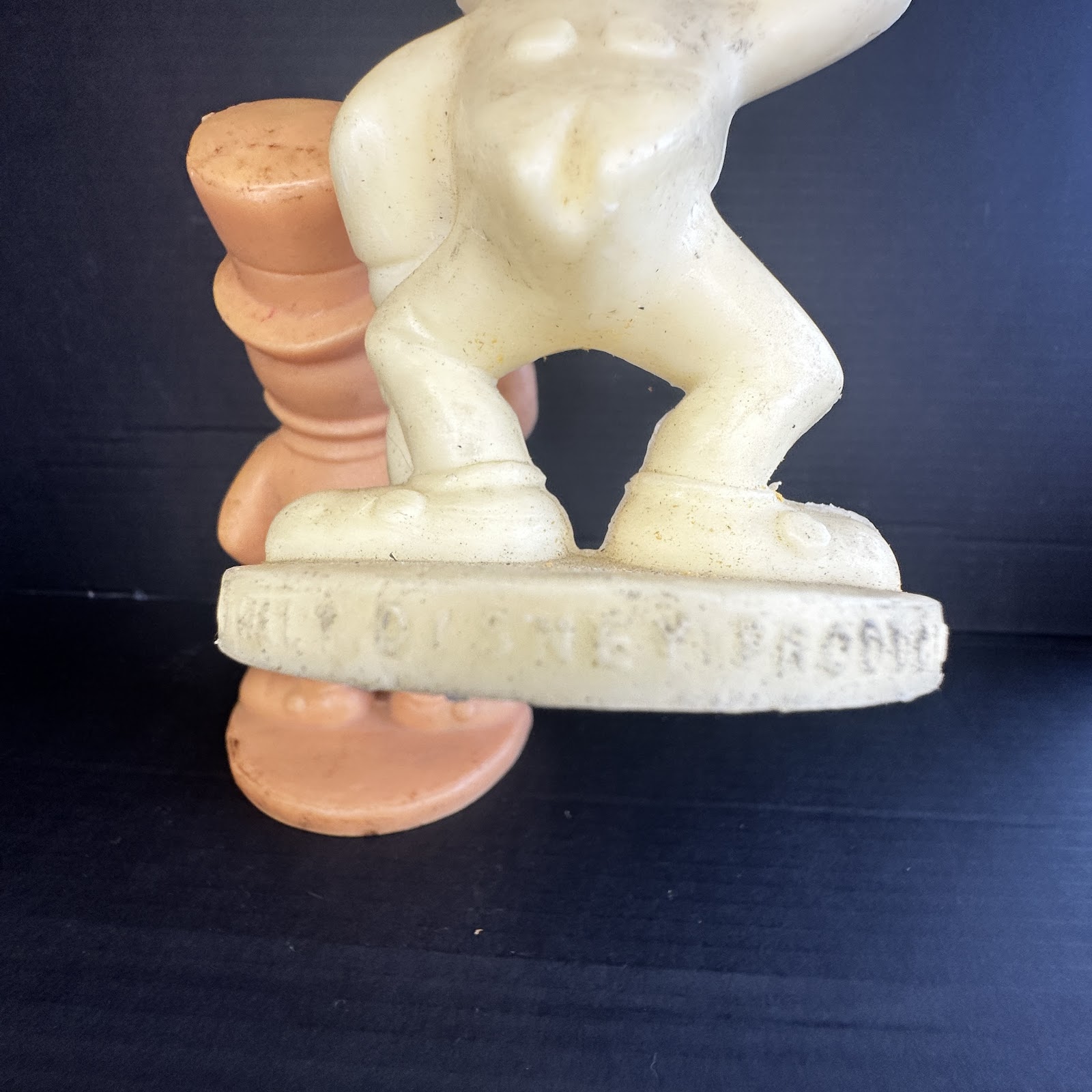 Vintage cream plastic blow-mold Donald Duck figure showing sailor outfit and embossed Walt Disney Productions copyright mark on base, with aged yellowing patina