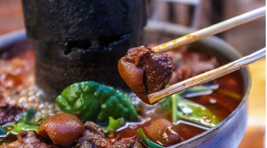 Lẩu dê đen nóng hổi, khói nghi ngút, với hương thơm nồng nàn