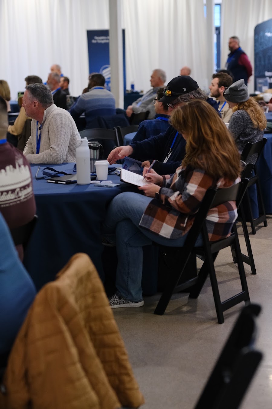 Attendees at their tables during a session at Colorado RE•CON