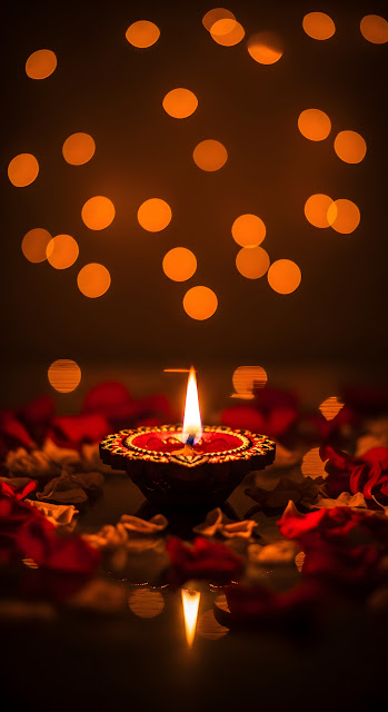 Glowing Diya Lamp Bokeh Lights and Rose Petals Diwali Scene - Free mobile Wallpaper