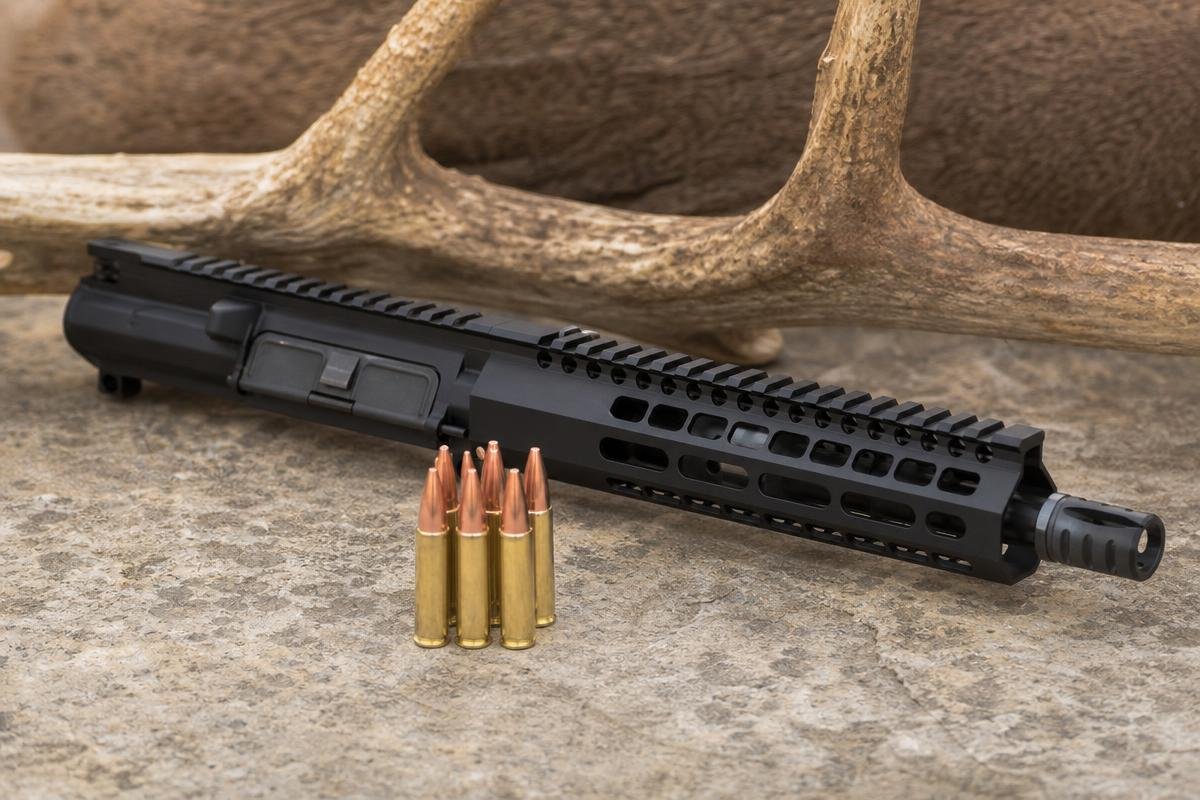50 Beowulf upper receiver and ammunition showing why 50 Beowulf is good for hunting hogs and deer