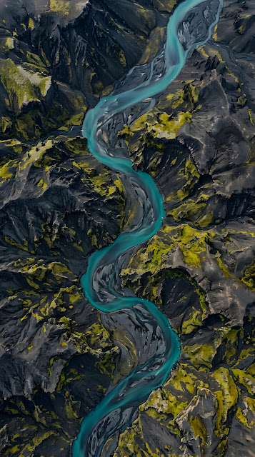 Aerial Top-Down View of Teal River Winding Through Mossy Volcanic Mountains - Free mobile Wallpaper