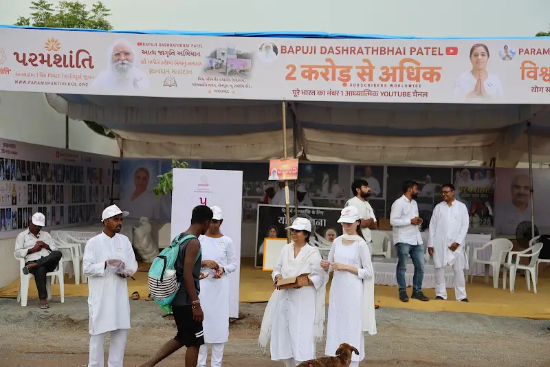 Visitors at the camp beneath the 2 crore banner.