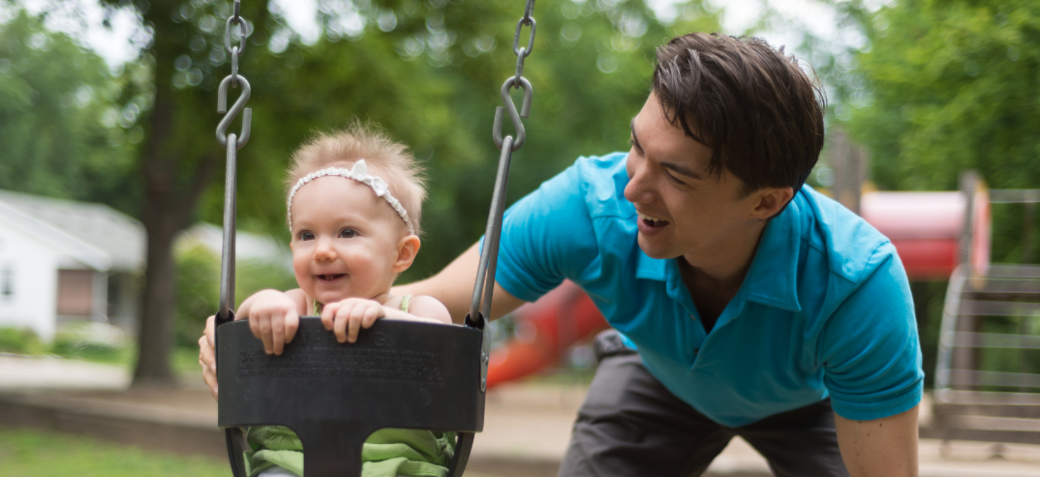 Two parents caring for their baby son — baby development support for families at 9–12 months