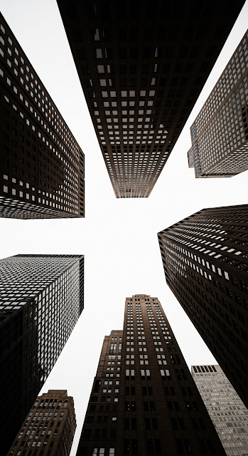 Extreme Low Angle Looking Up at a Cluster of Converging Skyscraper Facades Against Sky - Free mobile Wallpaper
