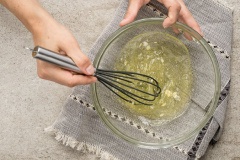 Mở sẵn lò nướng ở 190 độ C. Cho 1/4 muỗng cà phê cream of tartar vào âu cùng 6 lòng trắng trứng rồi dùng cây đánh trứng đánh đến khi hỗn hợp xốp mịn. Tiếp đó chế hỗn hợp lòng trắng vào máy xay rồi rây 200g bột hạnh nhân vào âu cùng bơ, baking soda, giấm táo và bột dừa. Bật máy xay thật nhuyễn mịn hỗn hợp.