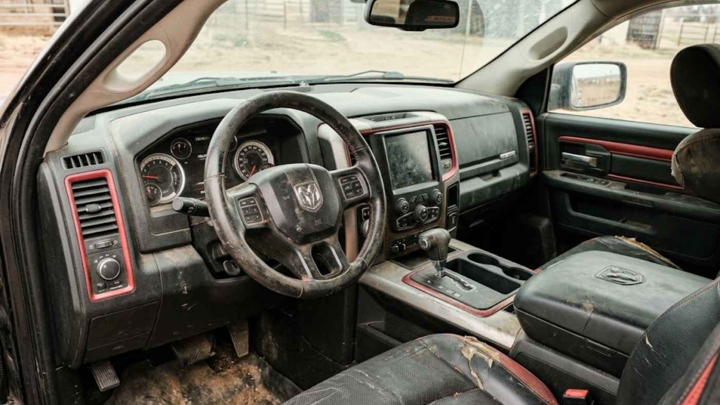 Mud-stained Ram 1500 Rebel interior showing why seat covers need trail-ready fit, fast cleanup and bolster protection.