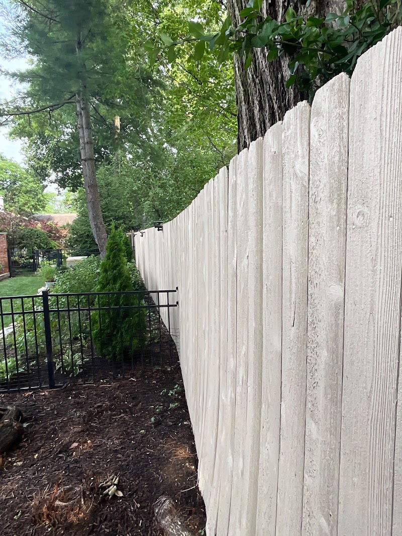 Roundtree border fence after staining, even color across the run beside new mulch