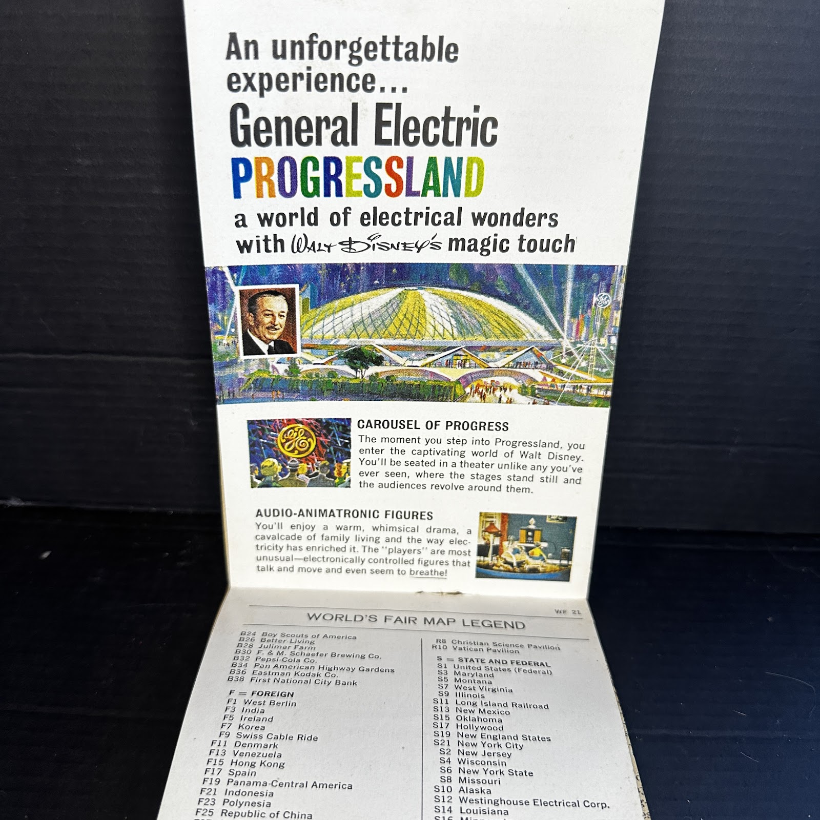 General Electric Progressland fold-out brochure from the 1964–1965 New York World's Fair, closed to show vertical format with GE dome illustration and Walt Disney portrait