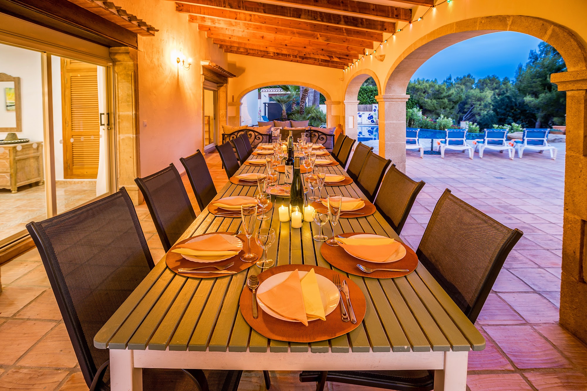 Long outdoor dining table set for dinner