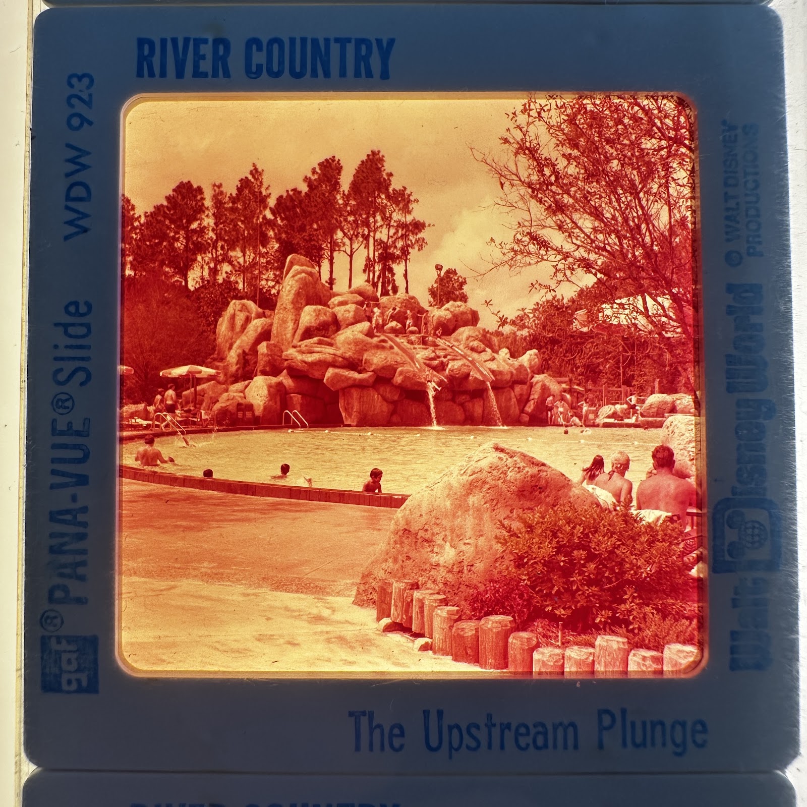 GAF Pana-Vue 35mm souvenir slide in plastic mount showing guests on the River Country Upstream Plunge water feature at Walt Disney World, 1976, with visible magenta color shift from dye aging