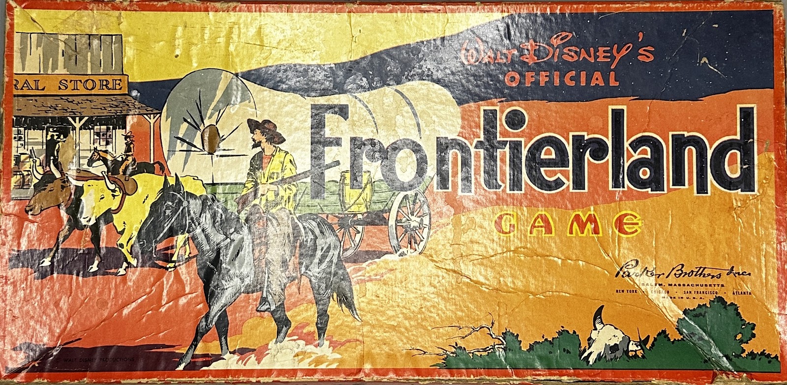 Walt Disney's Official Frontierland Game by Parker Brothers, 1955, with a coonskin-cap frontier scout and a covered wagon