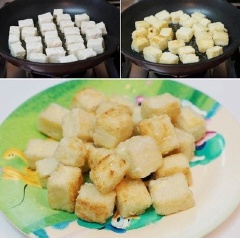 Làm nóng 2 muỗng canh dầu ăn trong chảo, cho đậu hũ non vào, chiên vàng giòn. Khi đậu hũ chín, gắp ra đĩa, để ráo dầu.