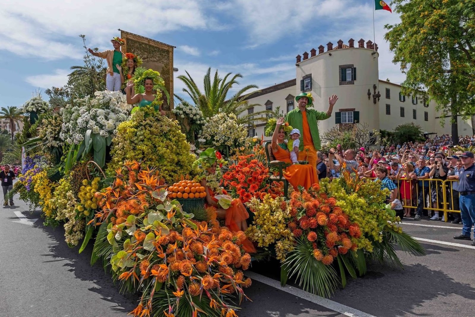 Colorful floral displays and participants celebrating the Madeira Flower Festival in Portugal.