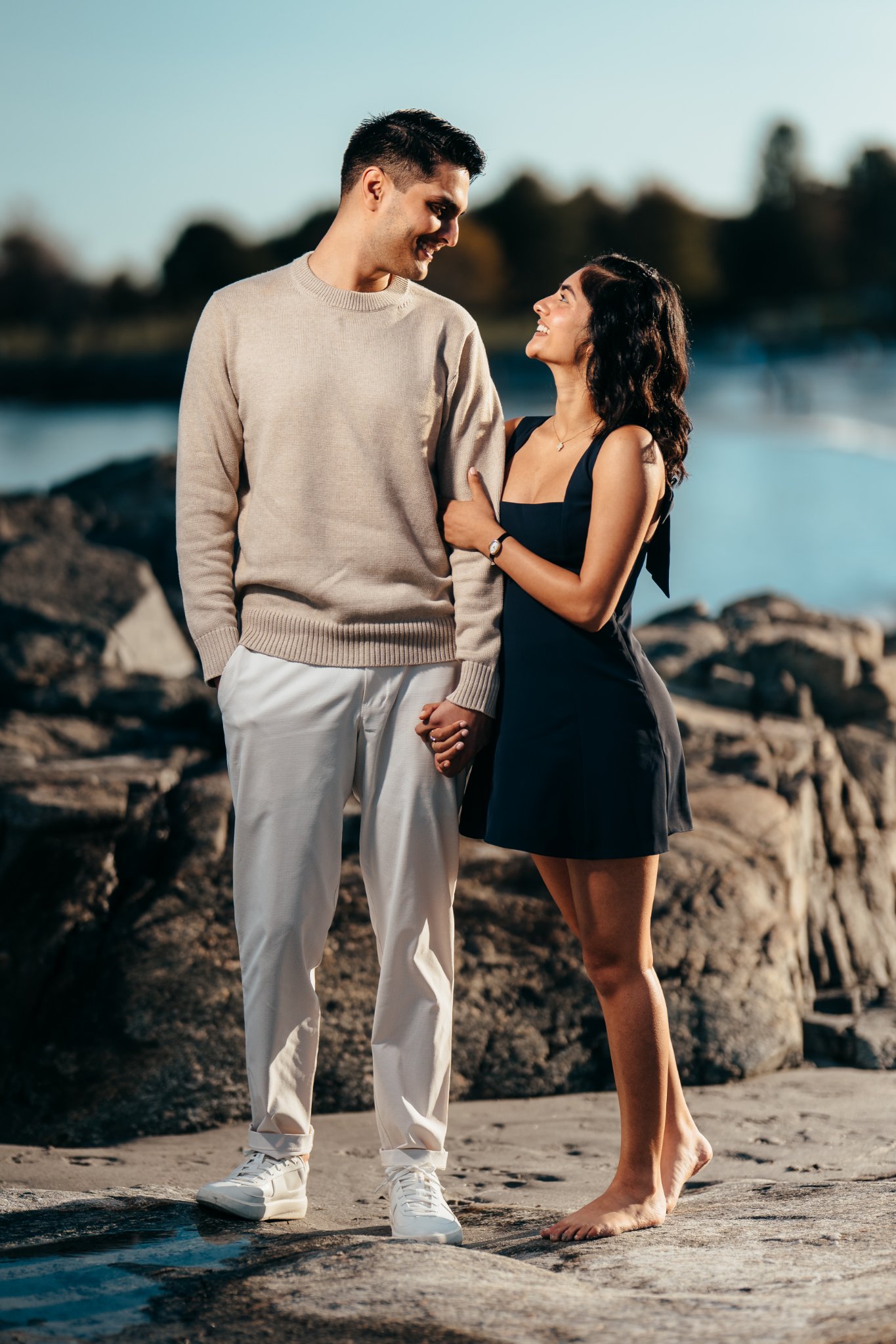 Sumeet and Jasmine standing together holding hands on the rocks