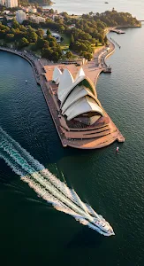 Golden Hour Aerial of Sydney Opera House and Harbor Boat