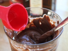 Đầu tiên cắt nhỏ 160g chocolate đen, cho vào ly thủy tinh to, thêm tiếp vào 80g kem sữa tươi, 10ml nước lọc, đun cách thủy và khuấy đều cho chocolate tan chảy hoàn toàn. Tiếp đến cho 15g bơ và 15ml rượu Cointreau vào, đun và khuấy cho quyện đều thành hỗn hợp đồng nhất là được.