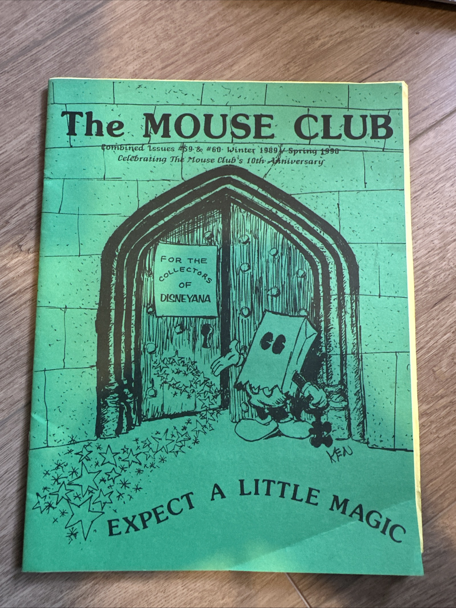 The Mouse Club combined issues 59 and 60, bright green cover with black ink illustration of pie-eyed Mickey Mouse in a paper bag disguise framed by a stone archway