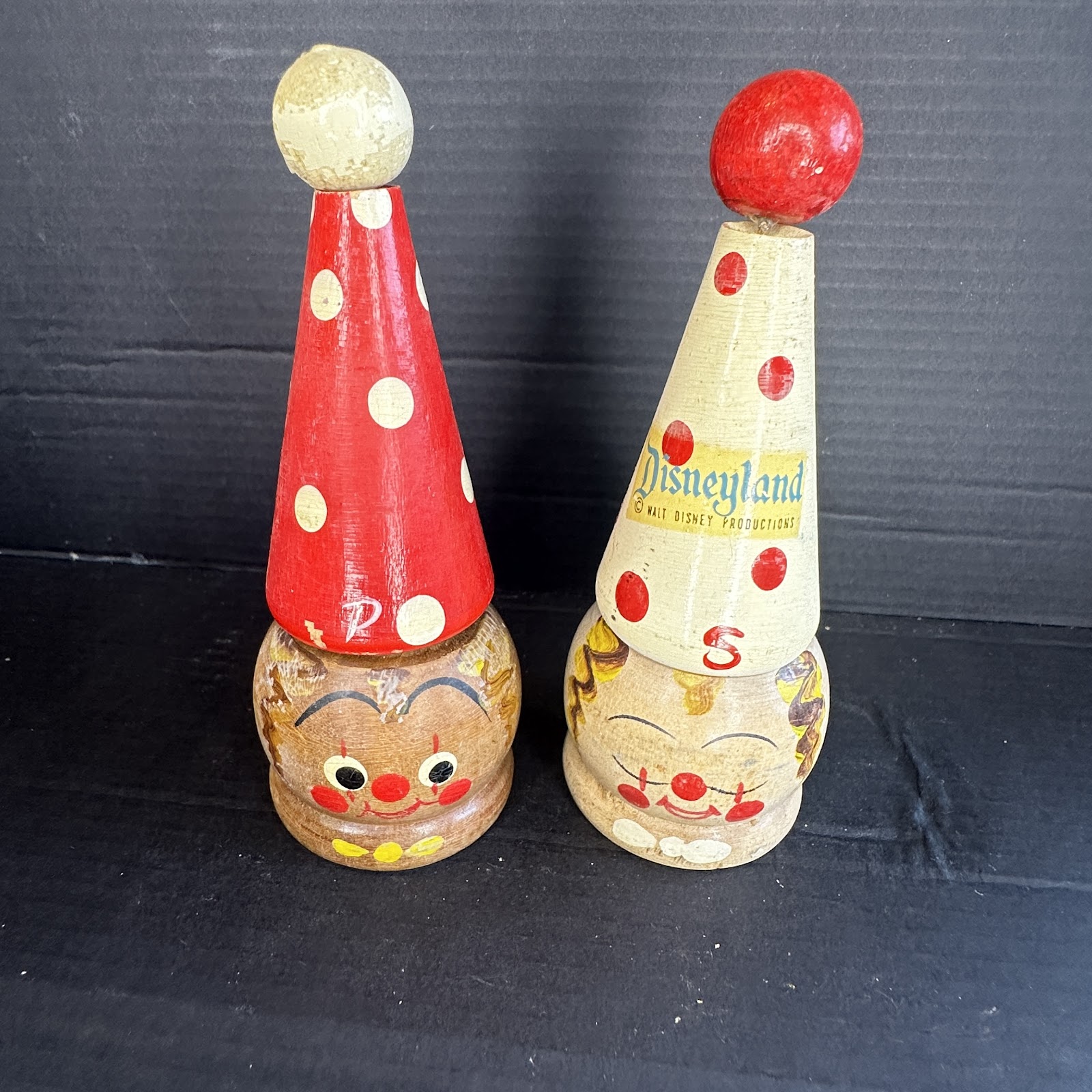 Pair of vintage hand-painted wooden Disneyland clown salt and pepper shakers, red-and-white pepper shaker and cream salt shaker with Walt Disney Productions decal, 1950s–60s