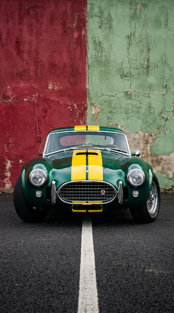 Classic Emerald Sports Car with Yellow Racing Stripes - Free mobile Wallpaper