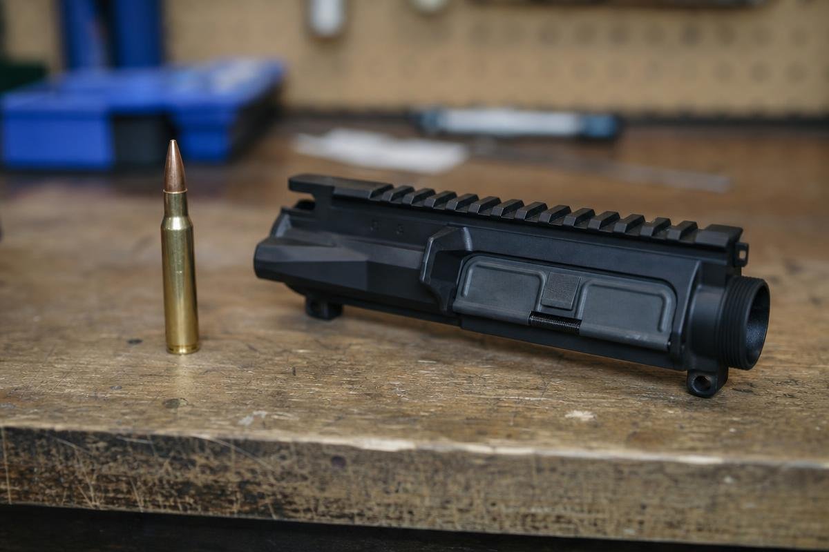 .308 Winchester cartridge and AR-10 upper showing what is 308 Winchester good for