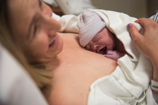 A parent and baby, preparing for breastfeeding before birth