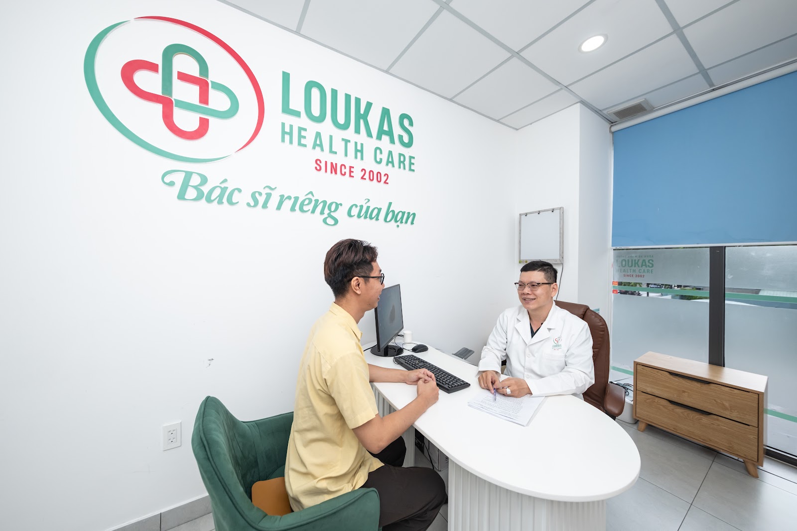 Portrait featuring a multi-ethnic medical team smiling confidently at the camera while gathered in a bustling hospital corridor