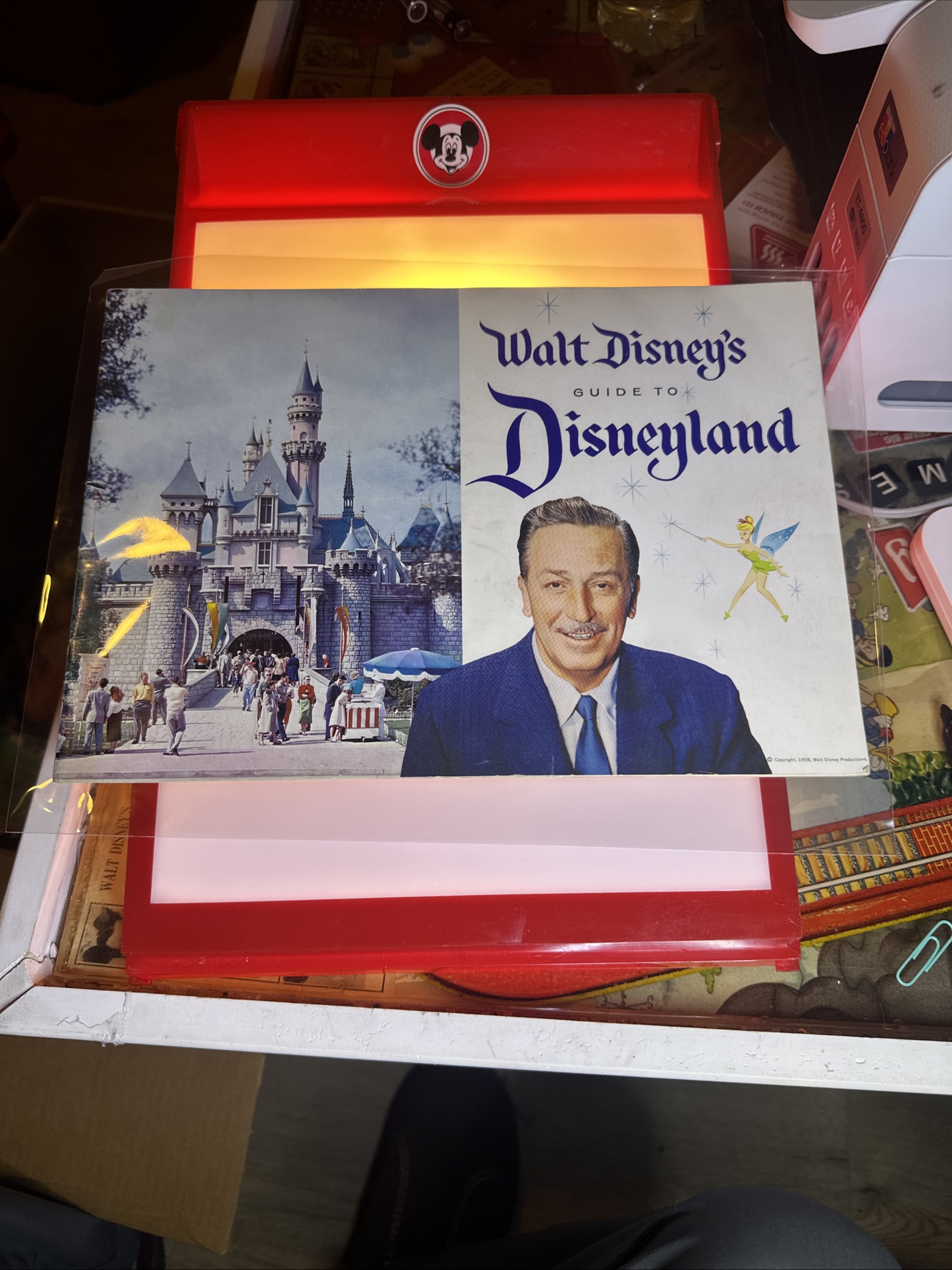 1958 Walt Disney's Guide to Disneyland landscape guidebook cover featuring Blue Suit portrait of Walt Disney, Tinker Bell illustration, and Mickey Mouse logo