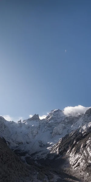 Sunburst Over Snowy Mountain Peaks 4K Wallpaper Background