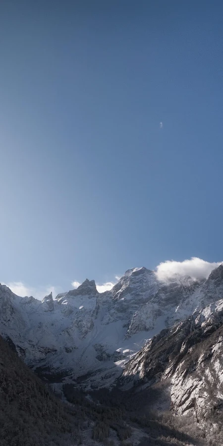 Sunburst Over Snowy Mountain Peaks 4K Phone Wallpaper