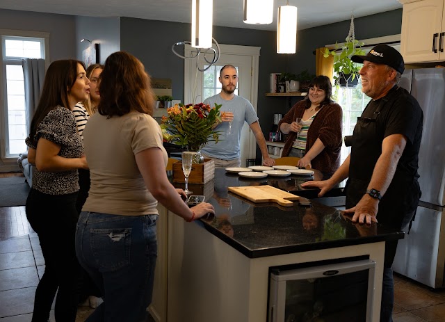 Standing around the table with guests