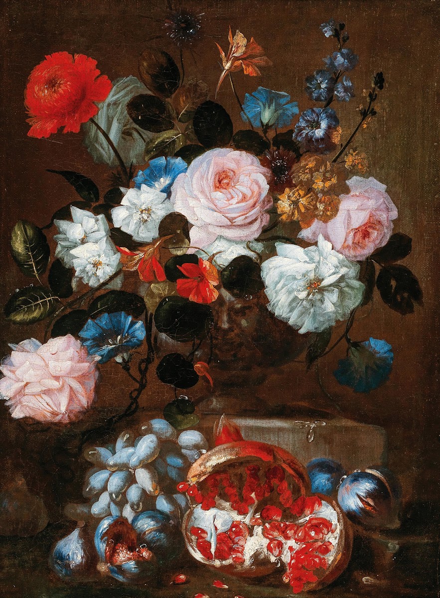 Flowers in a vase with grapes and a pomegranate