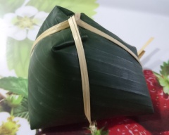 Mọi thứ đã xong giờ chỉ việc gói bánh. Trải 2 miếng lá chồng lên nhau, cho xíu dầu ăn lên lá rồi quấn lá lại như cái phễu. Múc 1 muỗng canh bột vô dàn mỏng ra rồi cho nhân, trứng cút vô. Múc thêm 1 muỗng bột vô dàn đều sao cho bột kín nhân rồi gói bánh, dùng dây lạt hoặc dây ni lông cột lại. Và làm tiếp cho đến hết.
