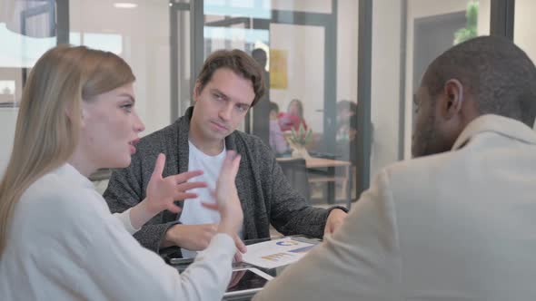 Colleagues Discussing Charts During a Business Meeting Free Download – Envato Elements