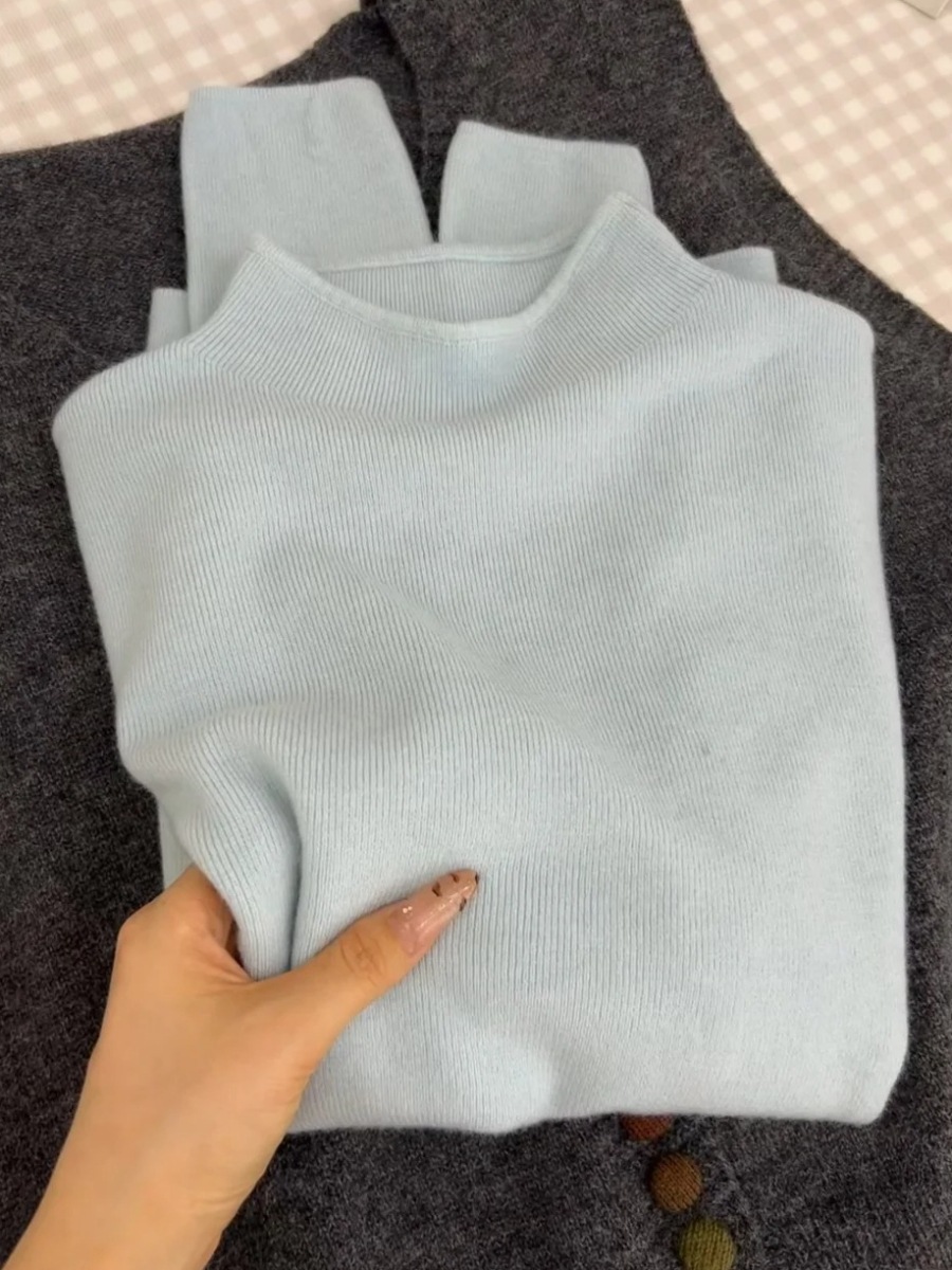 Women's knitted sweater with a small stand-up collar