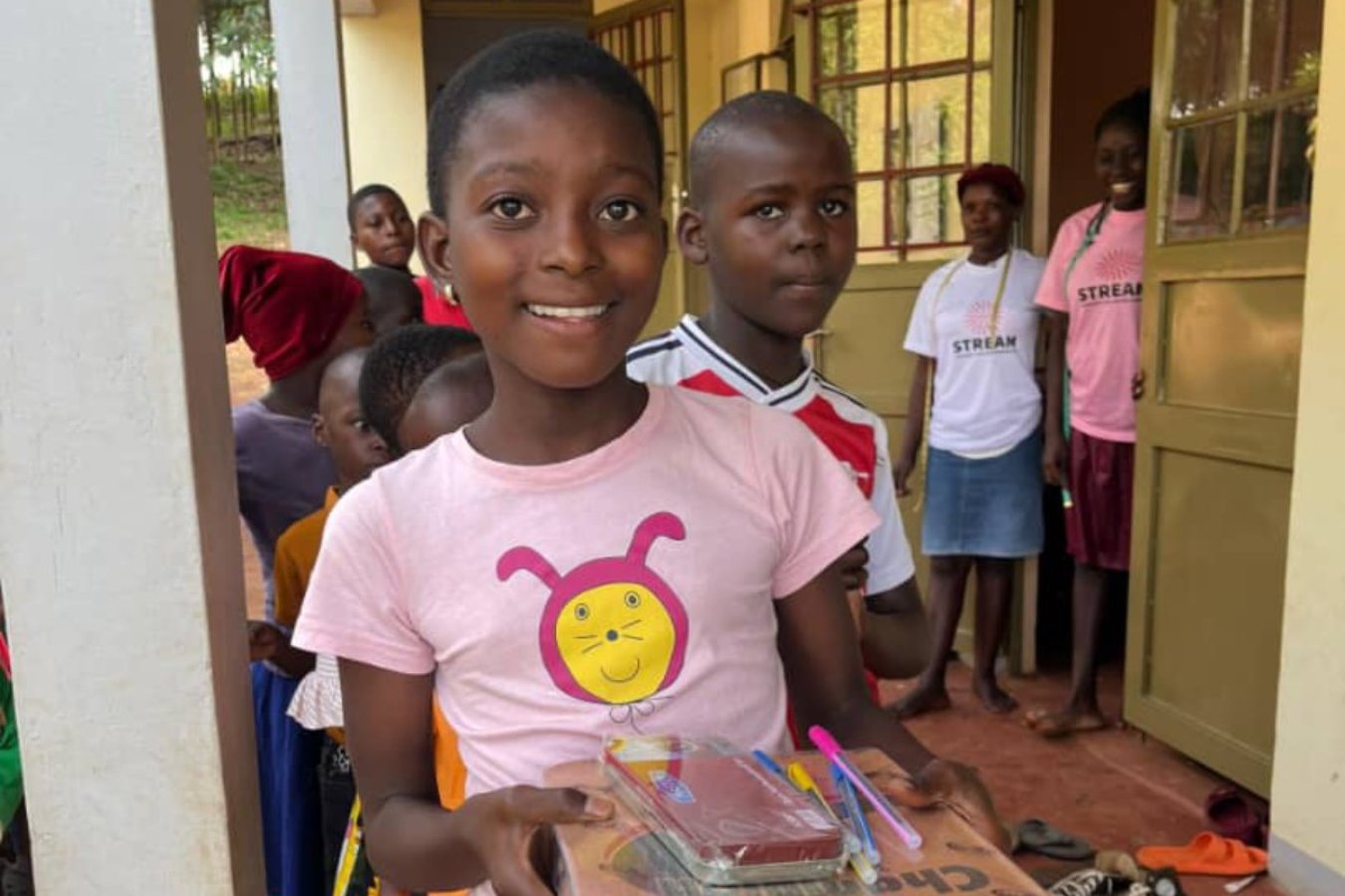 Girl holding school books and supplies