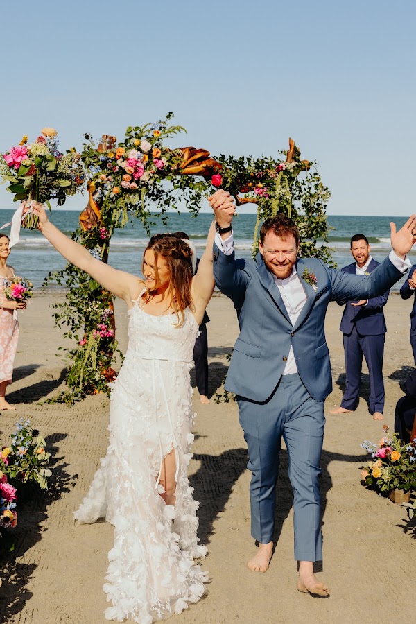 Newlyweds celebrating as guests cheer