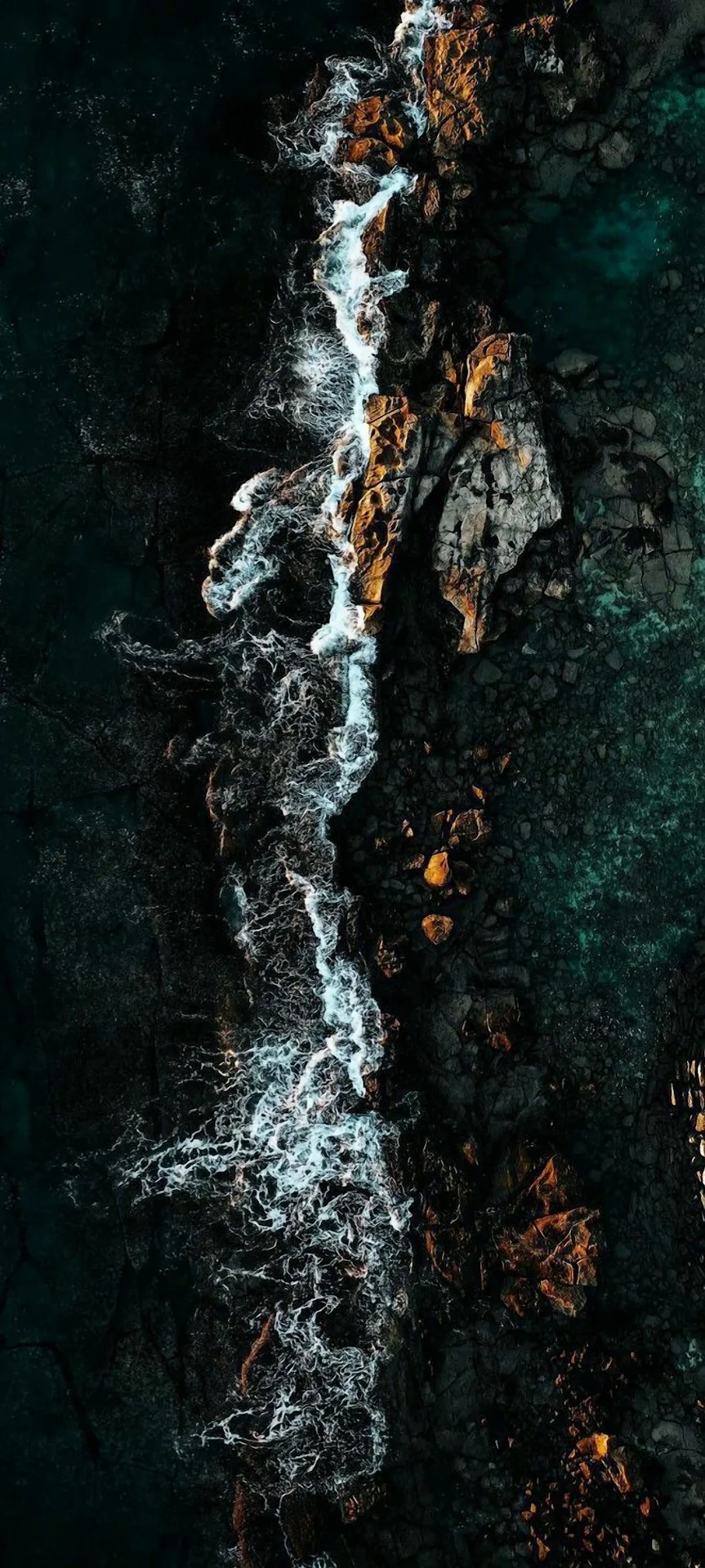 Moody Aerial View of Crashing Waves on Dark Volcanic Coastline - Free 4K mobile Wallpaper