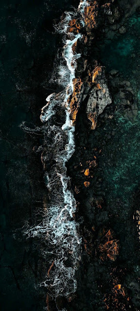 Moody Aerial View of Crashing Waves on Dark Volcanic Coastline - Free mobile Wallpaper