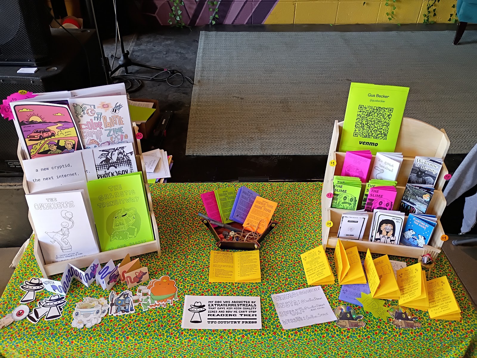 Photo of a table filled with zines of many colors and sizes